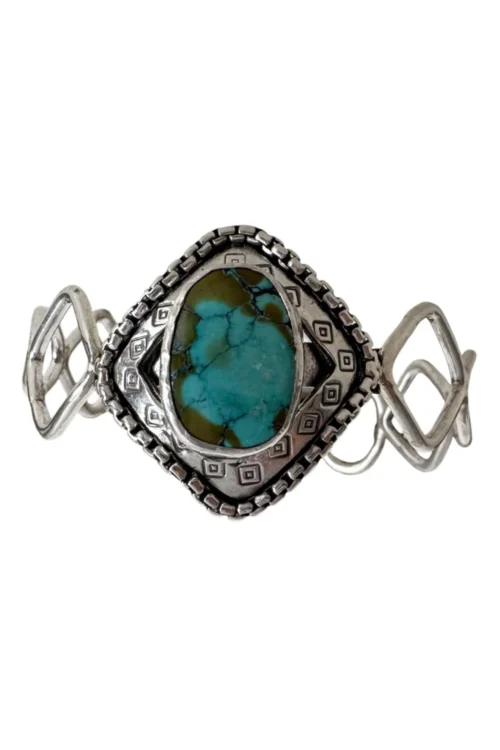 handmade boho style turquoise cuff with. sterling silver hand forged links of various shapes.